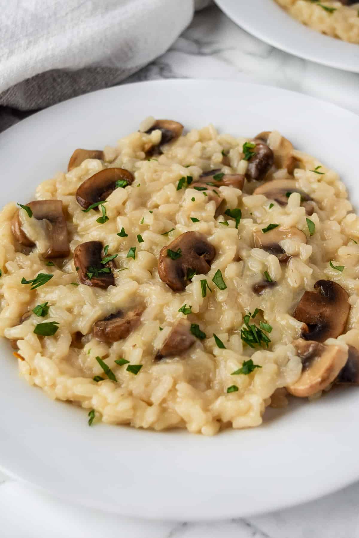 Baby Bella Mushroom Risotto on a white plate.