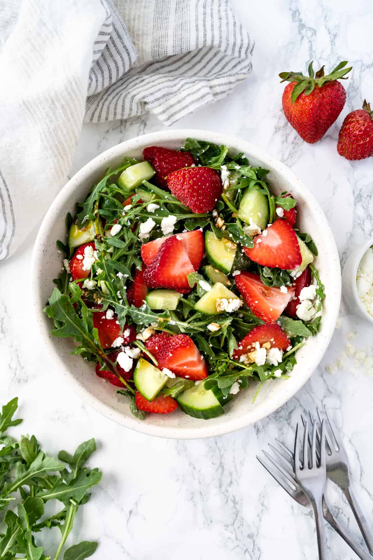 Cucumber Strawberry Salad with Arugula in a bowl.