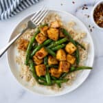 Teriyaki Tofu Stir Fry with Green Beans on a white plate with a fork.