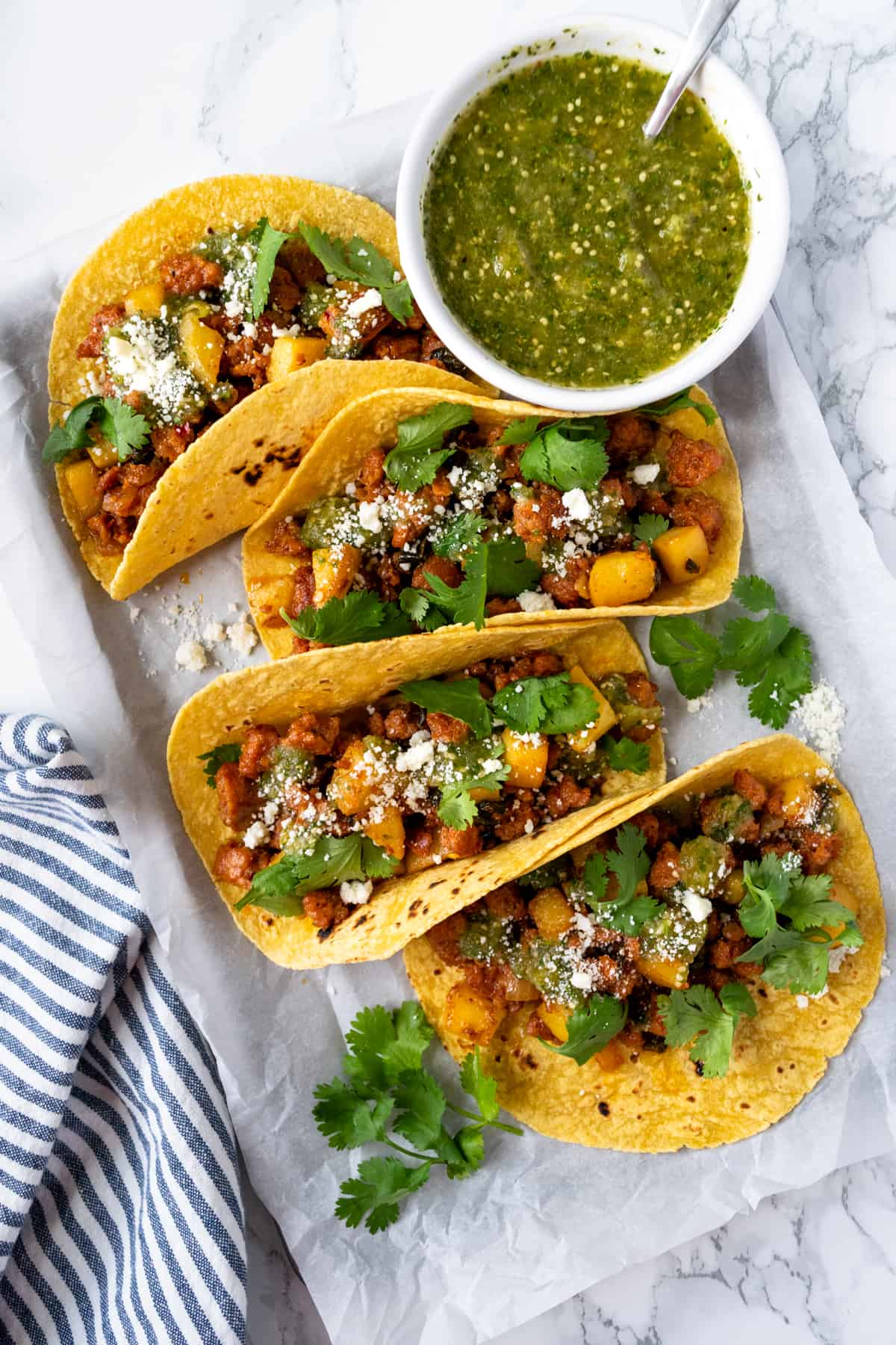 Chorizo Tacos with Salsa Verde on a baking sheet.