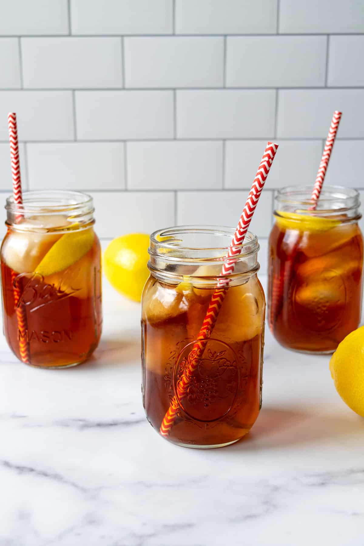 3 glasses of Earl Grey Iced Tea with red and white straws.