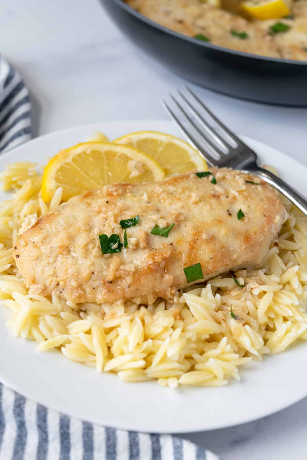Honey Garlic Lemon Chicken on a plate with orzo.