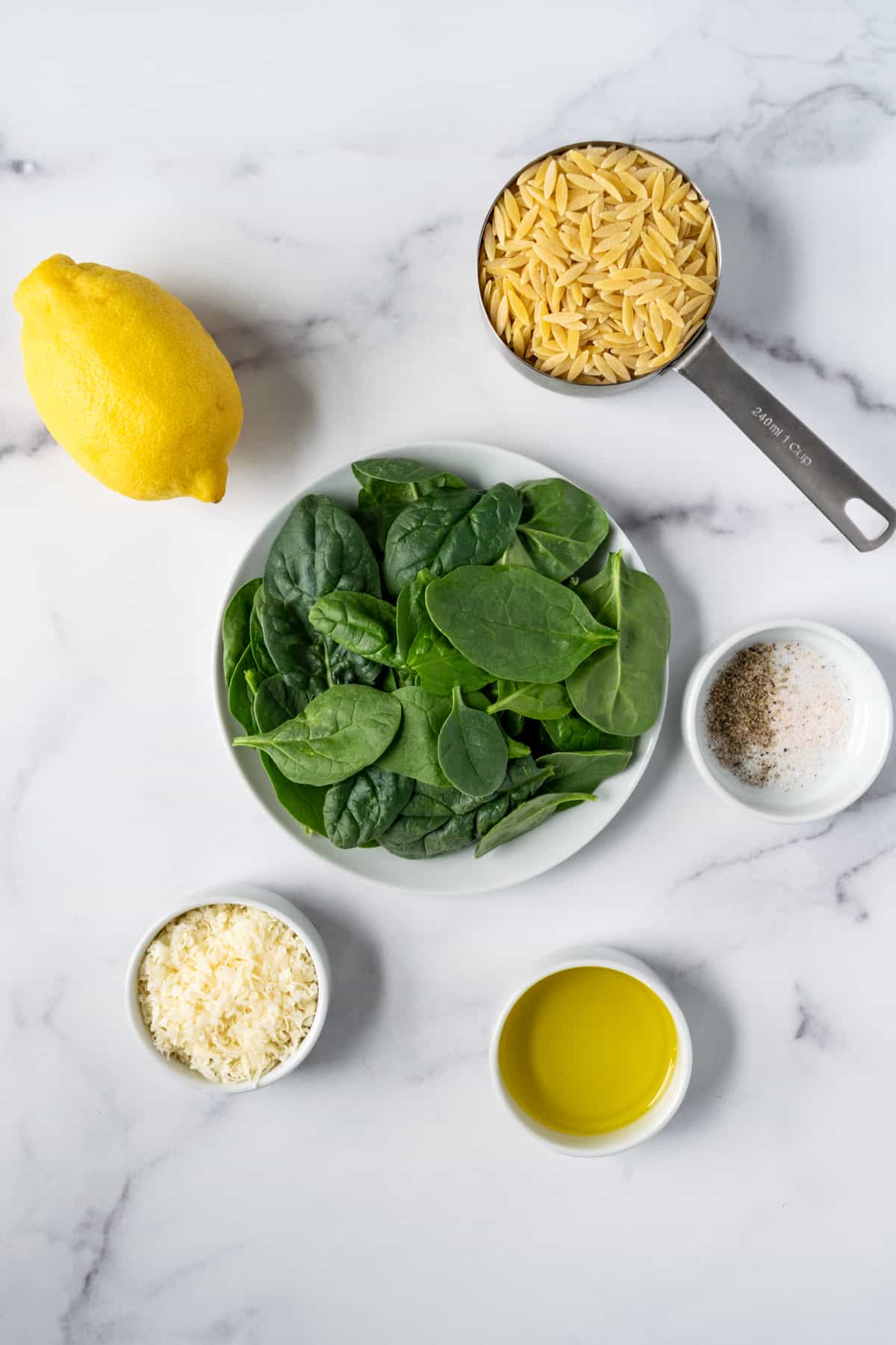Lemon Orzo with Spinach ingredients including lemon, spinach, parmesan, olive oil, orzo, salt and pepper.