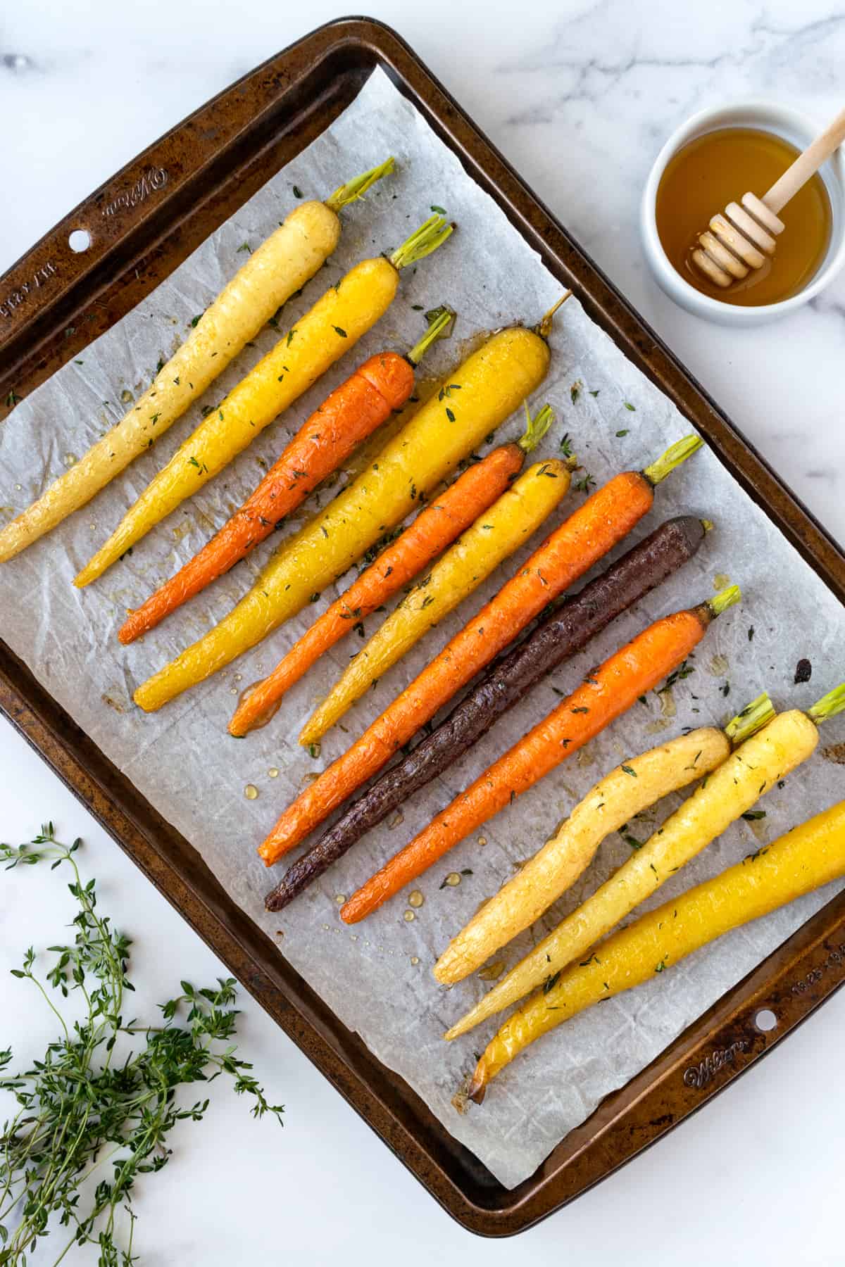Honey Thyme Roasted Rainbow Carrots on a baking sheet.