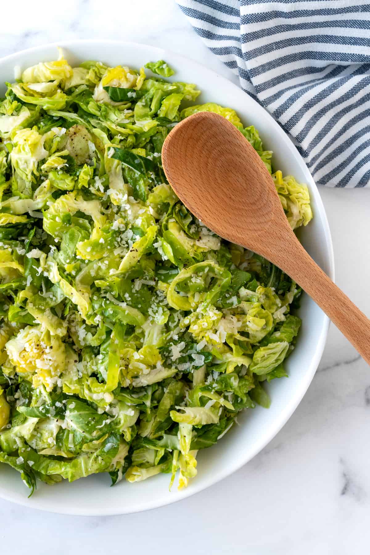 Parmesan Brussels Sprouts Salad in a white bowl.