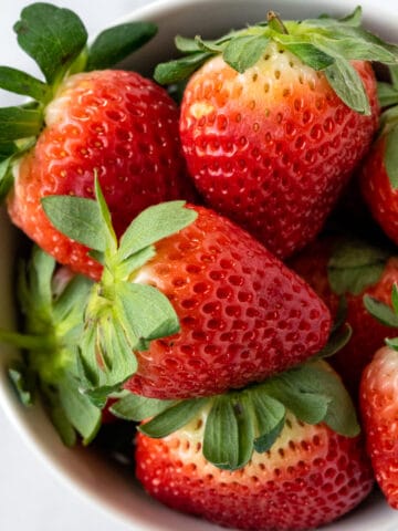 Fresh Strawberries in a white bowl.