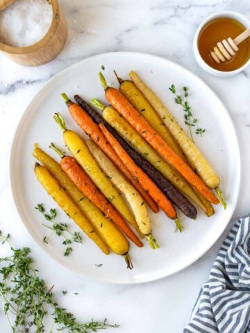 Honey Thyme Roasted Rainbow Carrots on white serving plate.