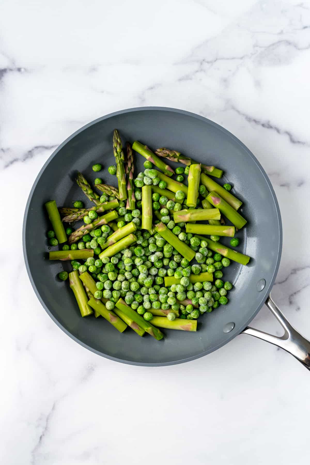 Asparagus and Peas in a skillet.