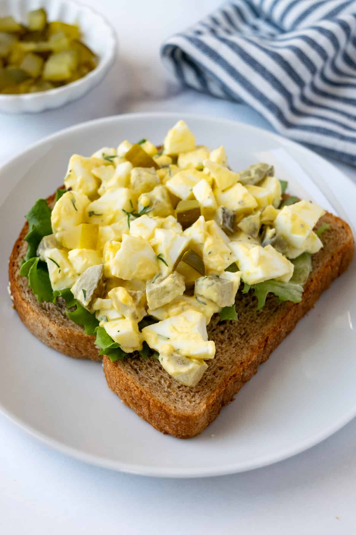 Egg Salad with Pickles on Wheat Toast.