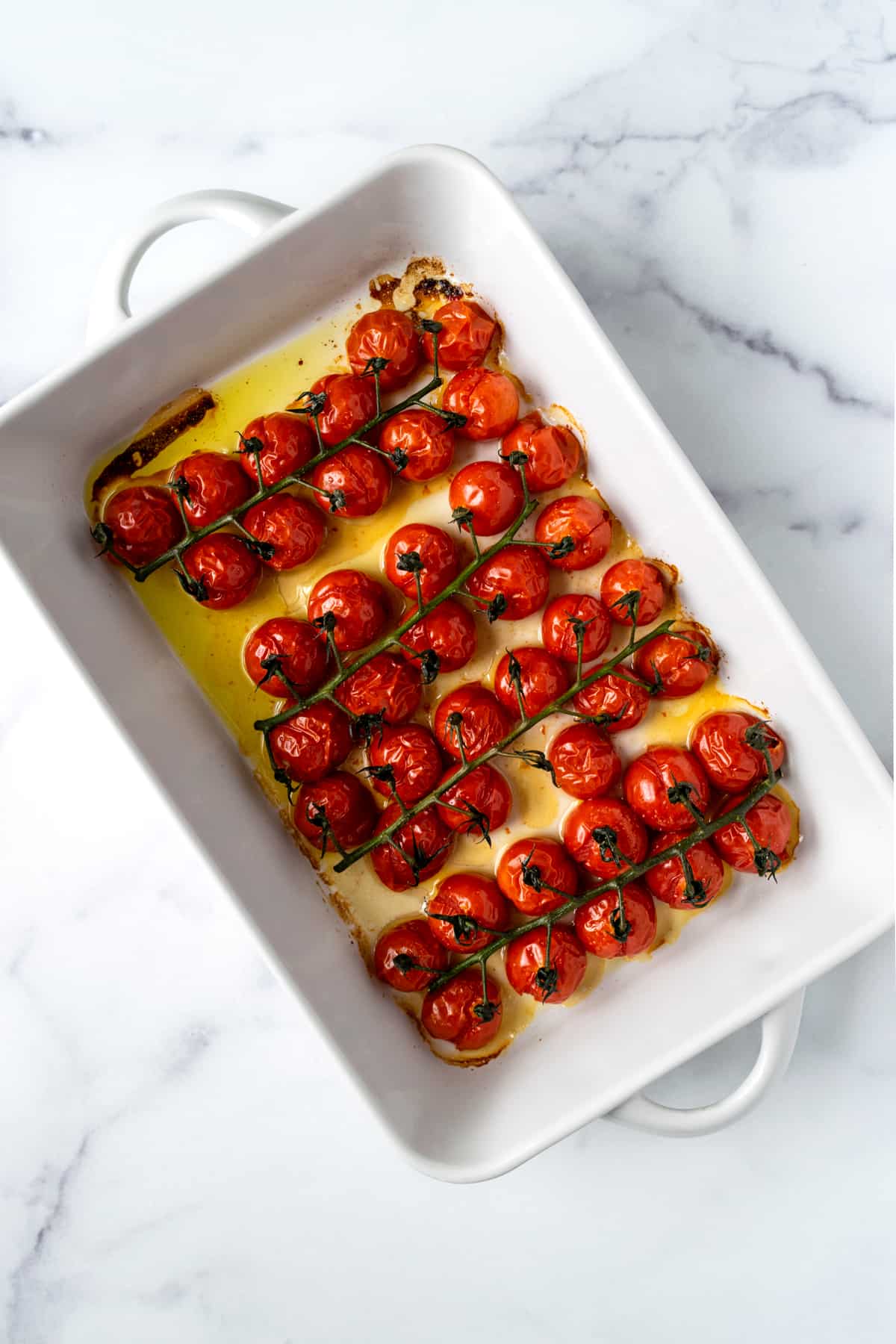 Baked Cherry Tomatoes in a white baking dish.