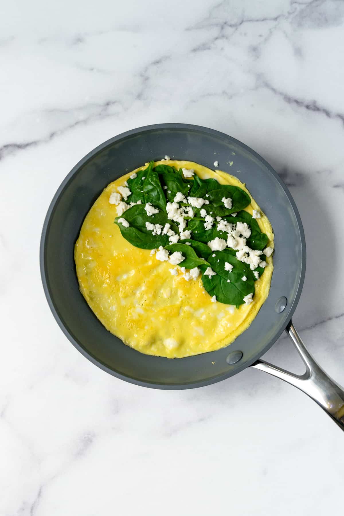 Omelet with Spinach and Feta in a Frying Pan.