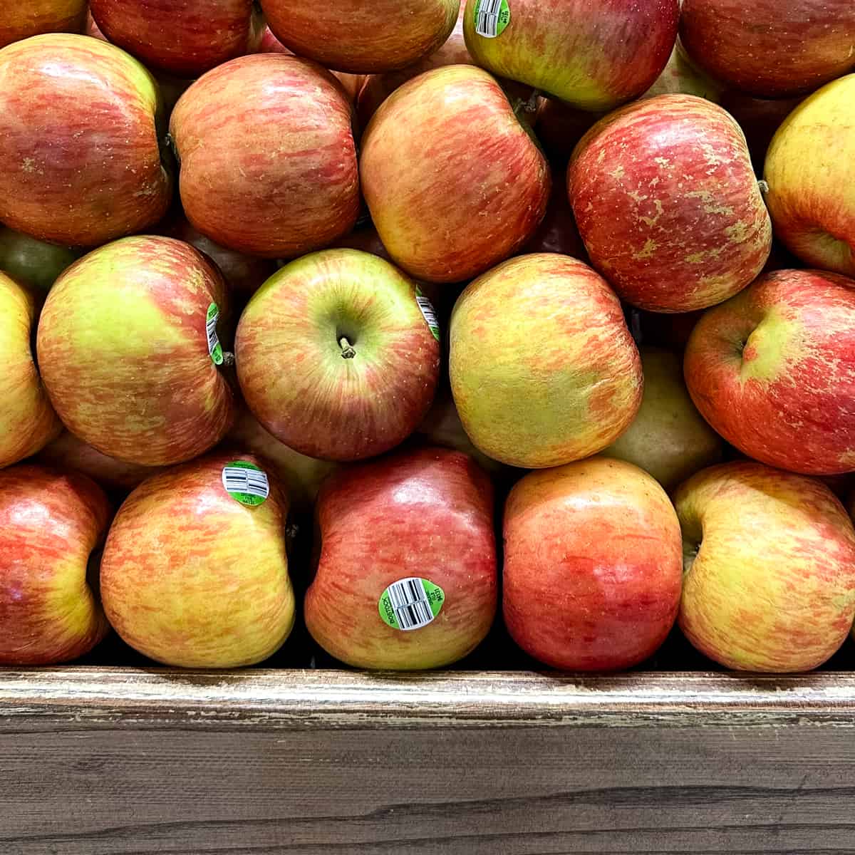 Apples Piled on a Wooden Shelf.