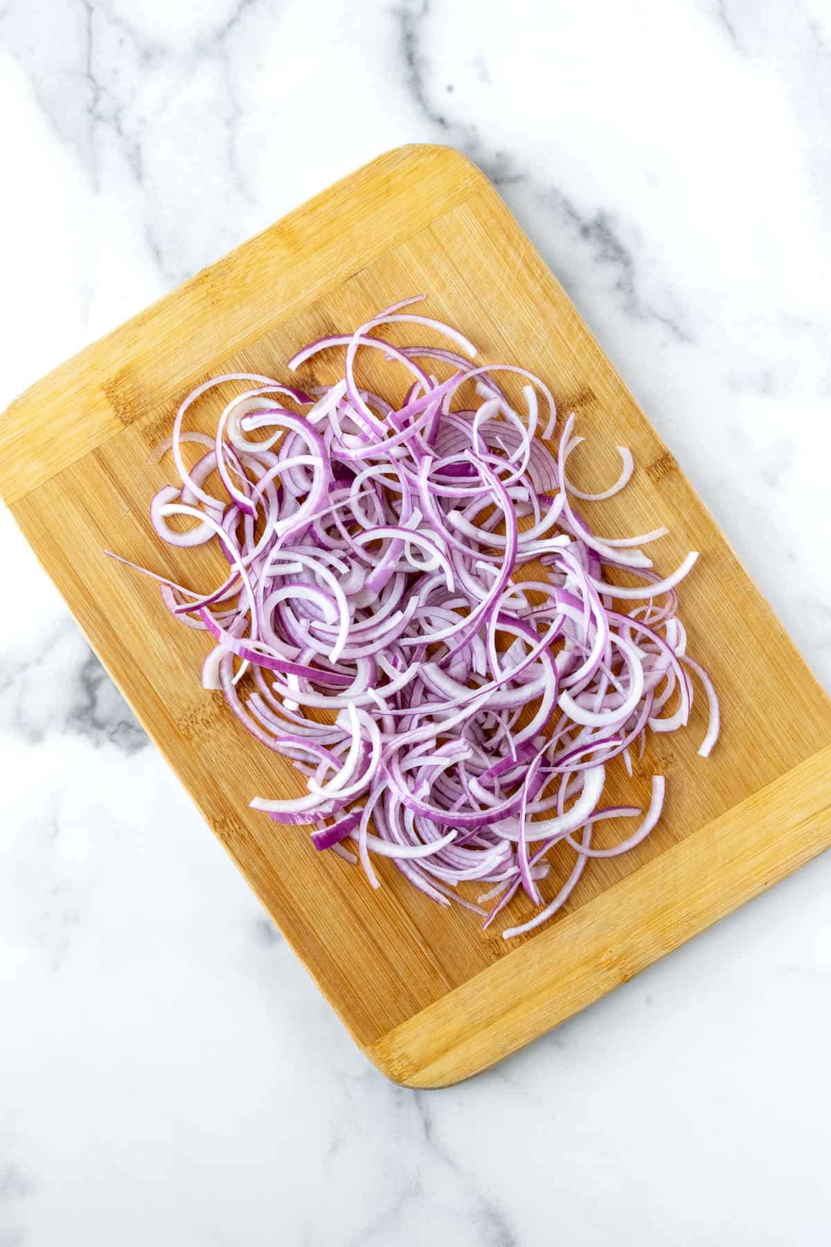 Sliced Red Onions on a Cutting Board.