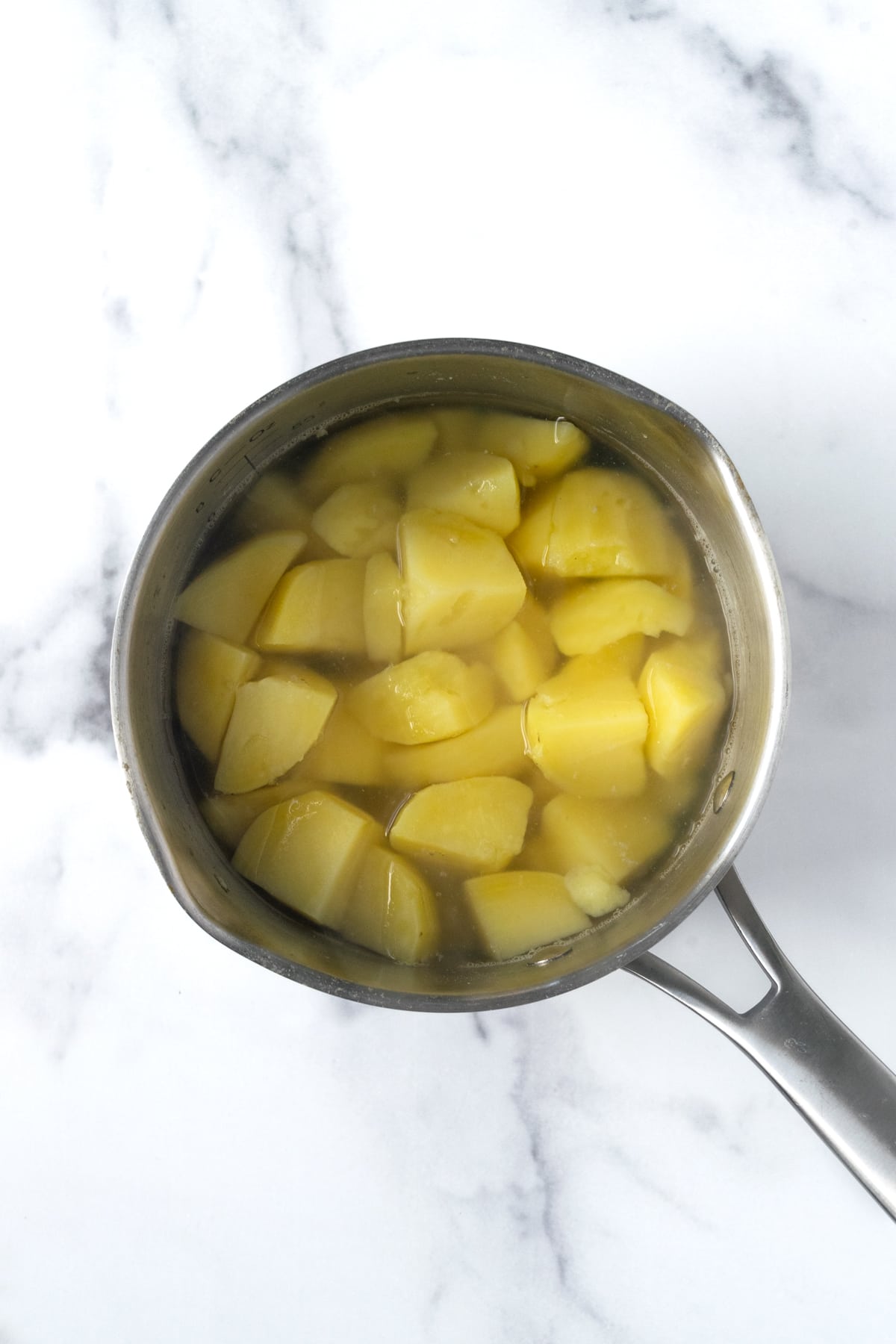 Cooked potatoes in pot of water for mashed potatoes.