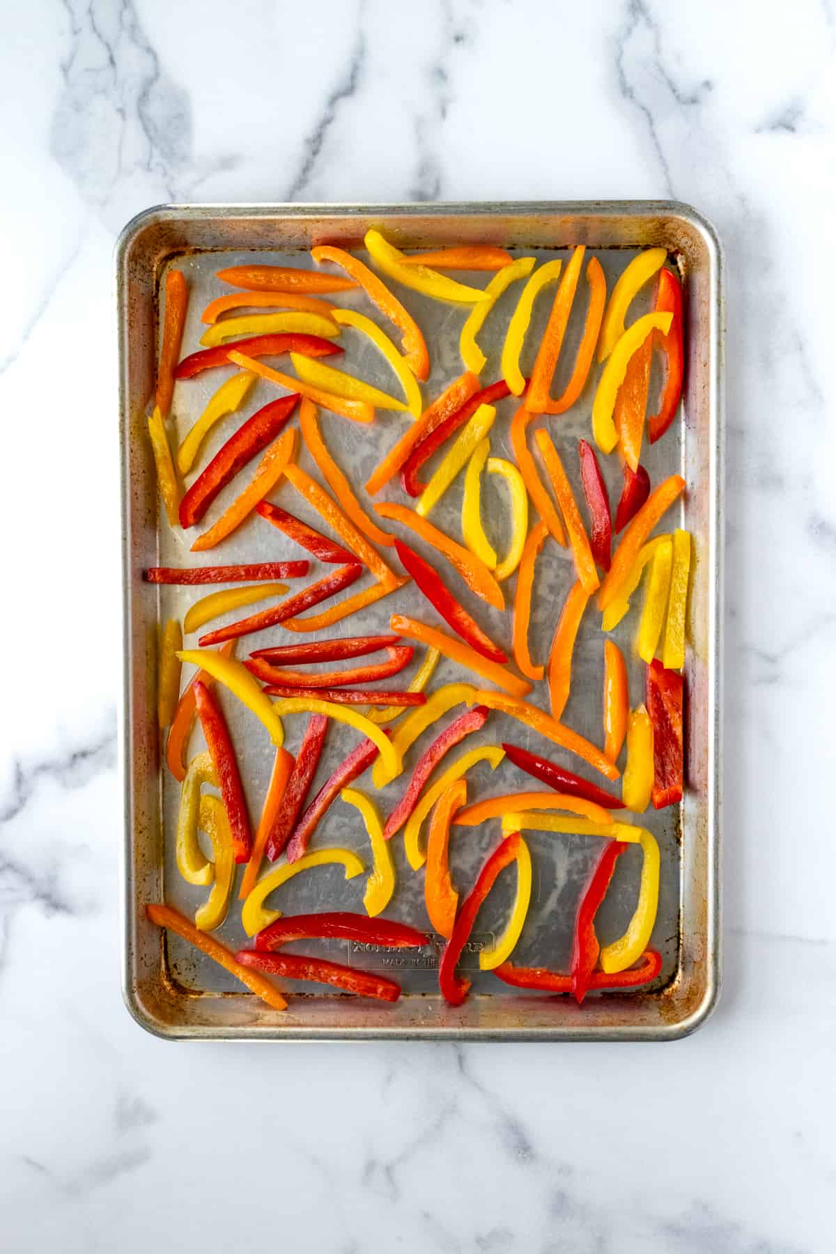 Bell pepper slices on a baking sheet.