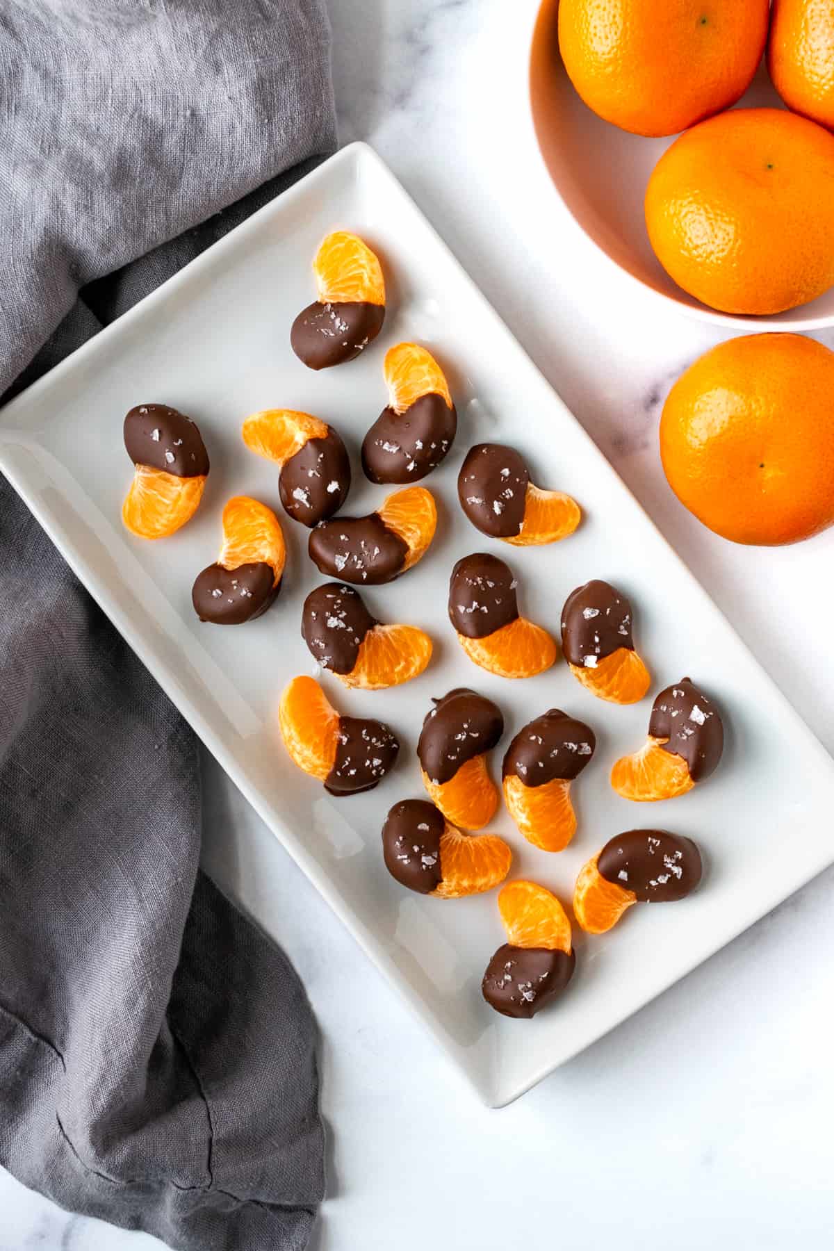 Chocolate Covered Oranges on a white rectangle serving plate.