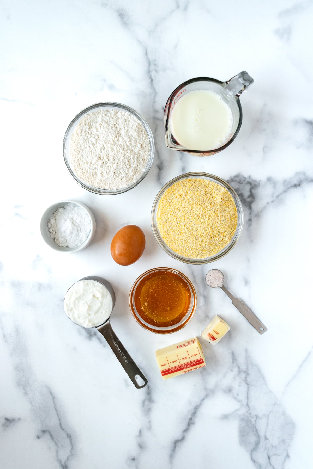 Honey Glazed Cornbread Ingredients on a marble countertop.
