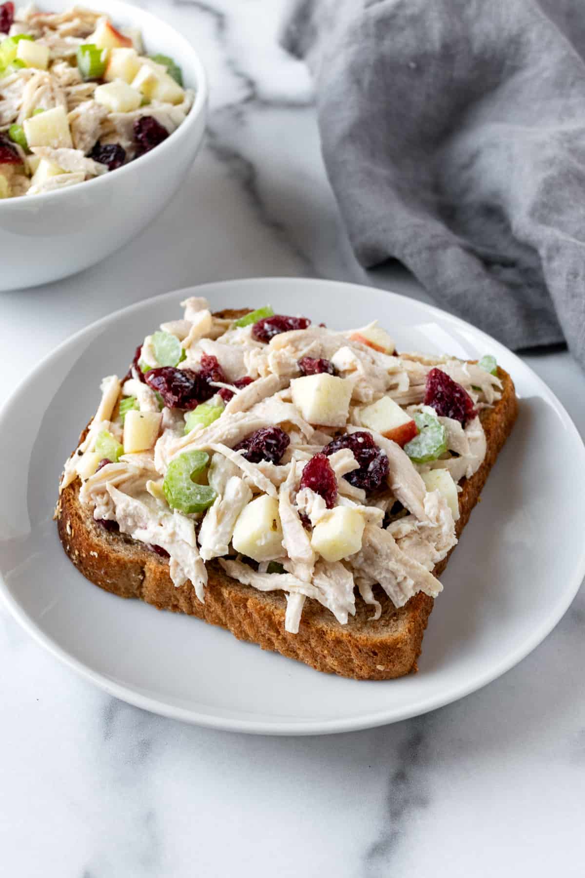 Apple Cranberry Chicken Salad on a piece of wheat bread.