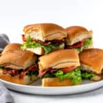 BLT Sliders on a white serving plate.