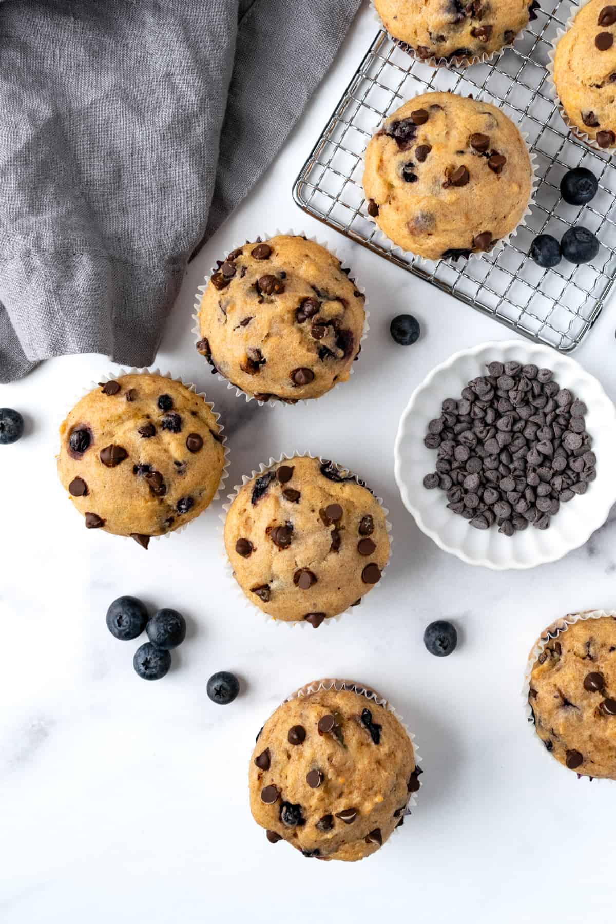 Chocolate Chip Blueberry Muffins on a marble countertop.