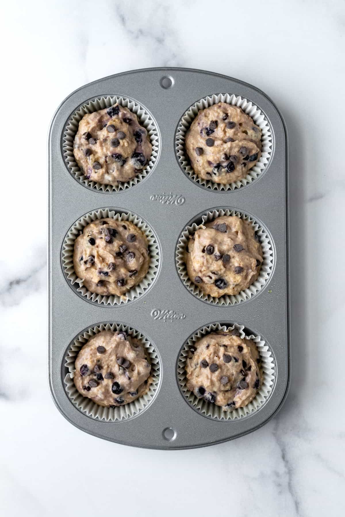 Blueberry Chocolate Chip Muffin Batter in 6 cup Muffin Pan.