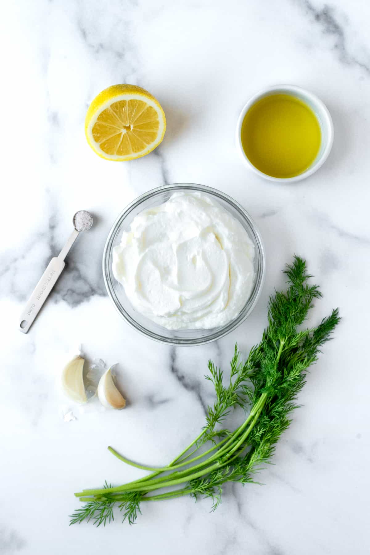 Greek Yogurt Dill Dip Ingredients on a marble countertop.