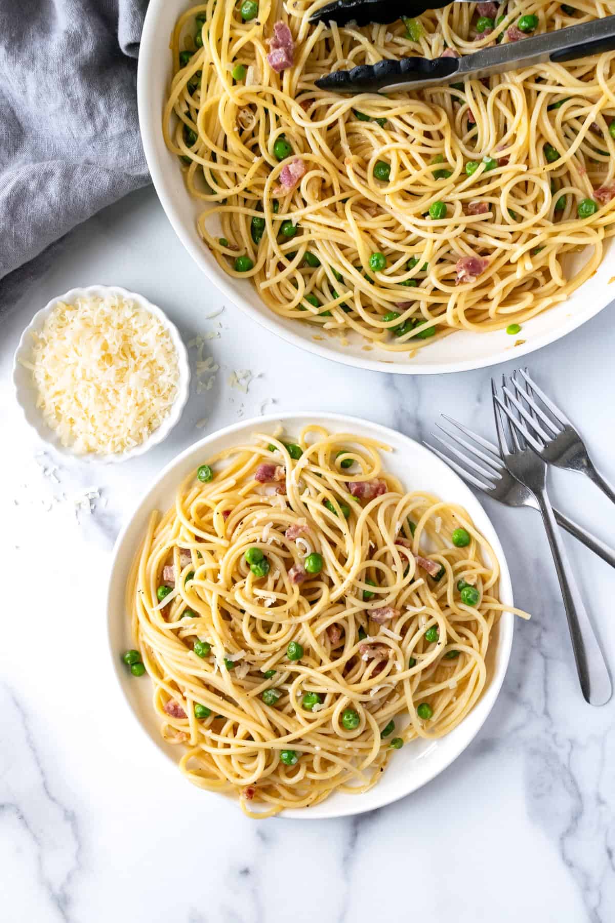 Pasta with Pancetta and Peas on a white plate.