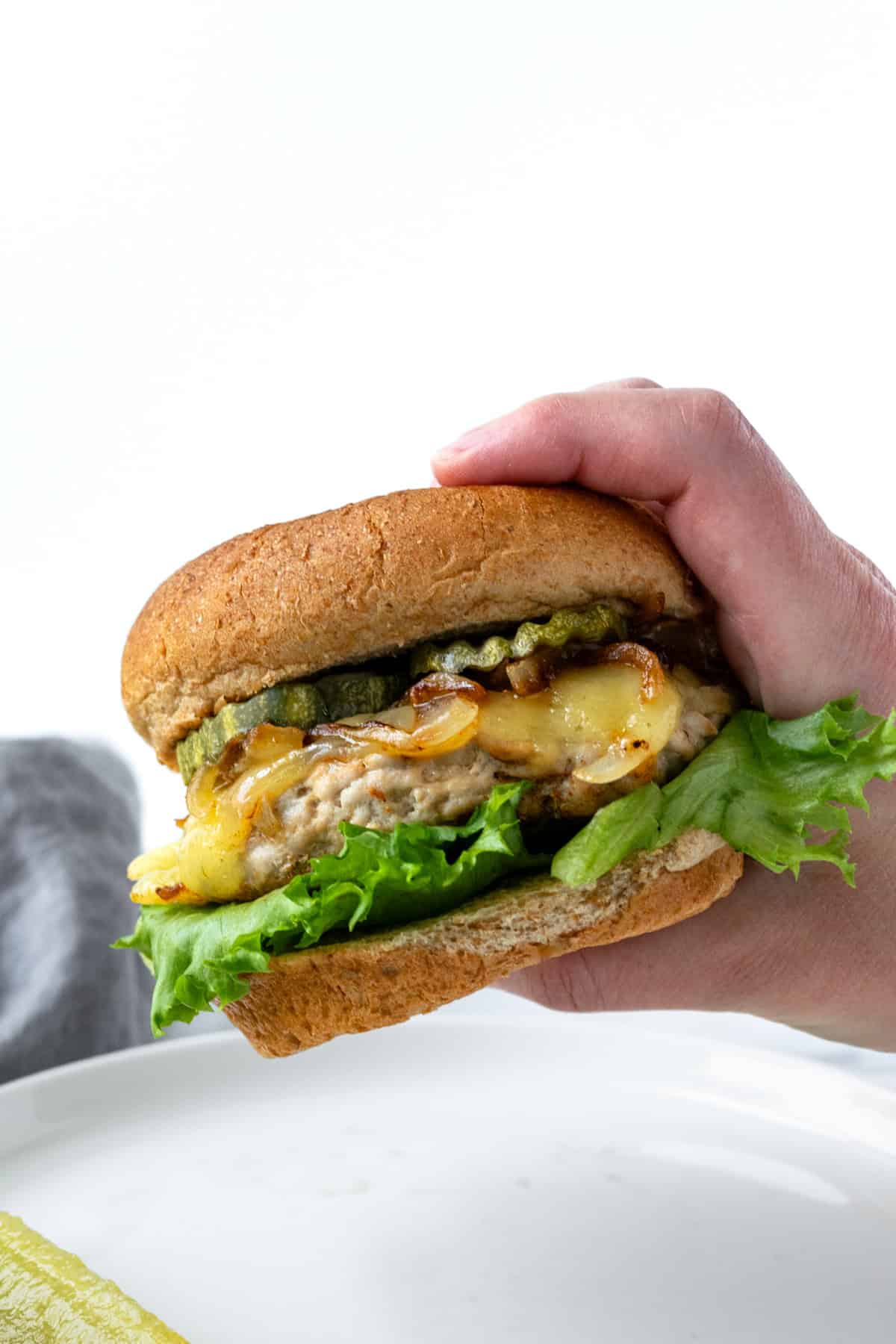 Hand Holding a Turkey Smash Burger.