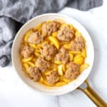 Skillet Peach Cobbler in a white ceramic skillet.