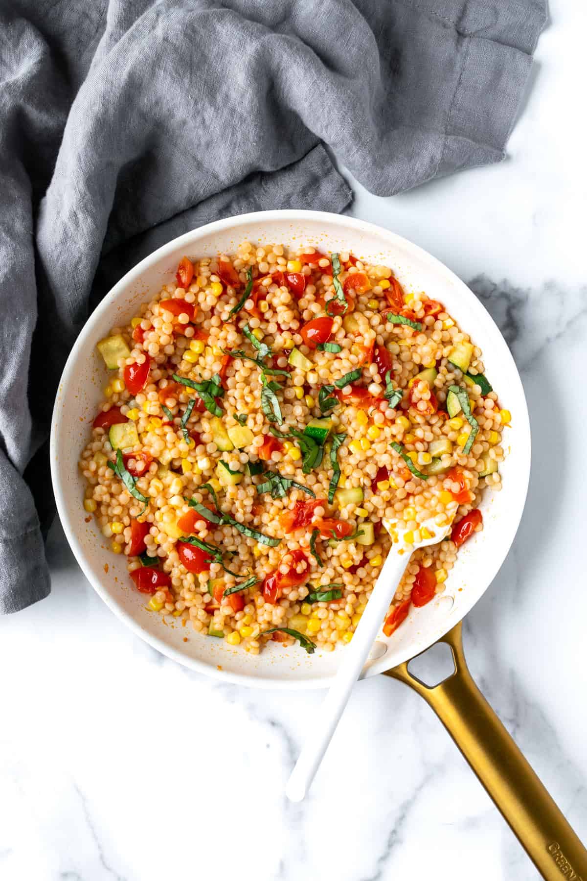 Summer Pearl Couscous in a white skillet.