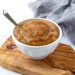 Cinnamon Applesauce in a white bowl with a spoon.