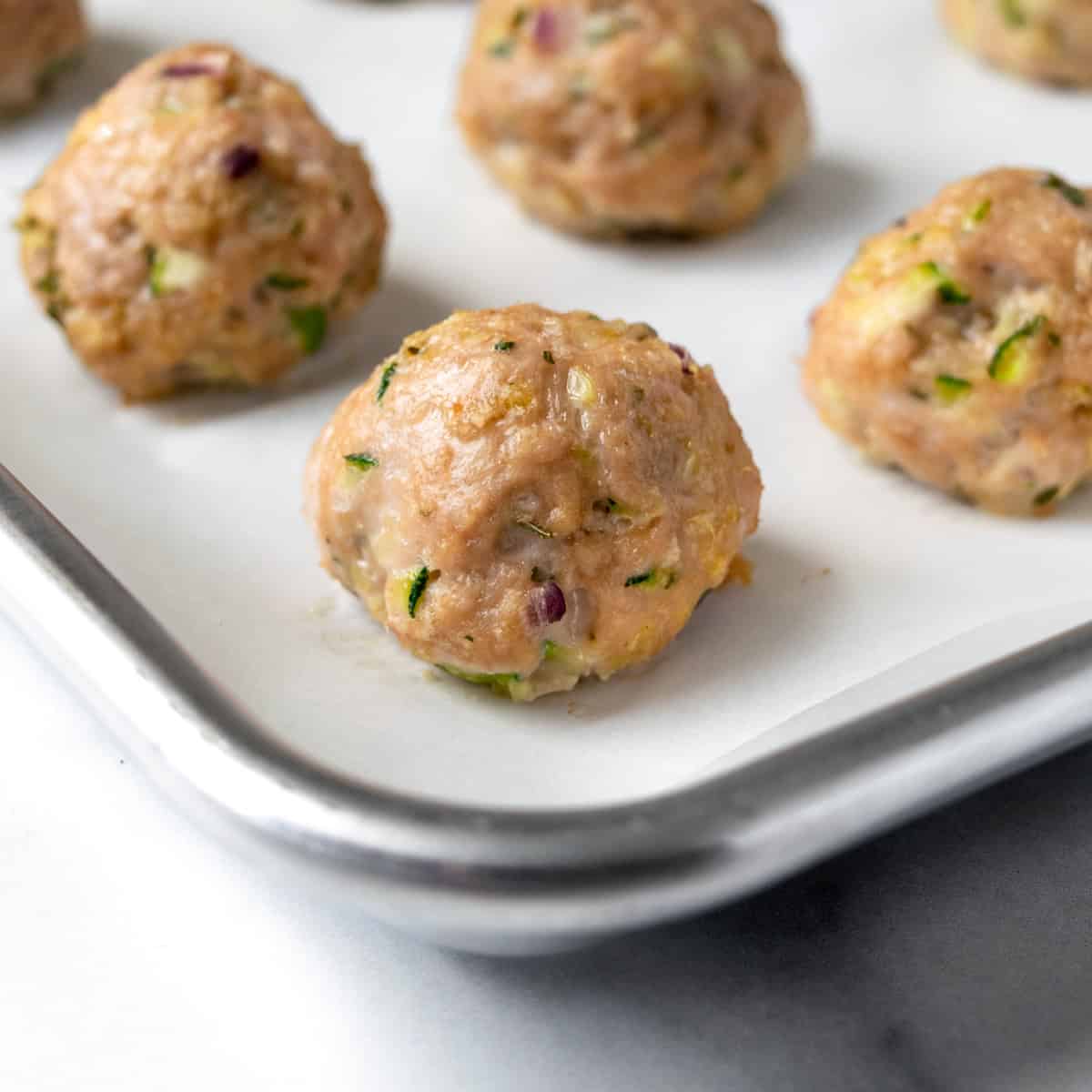 Turkey Zucchini Meatballs baked on a baking sheet.