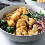 Roasted Cauliflower Bowls on a marble countertop.