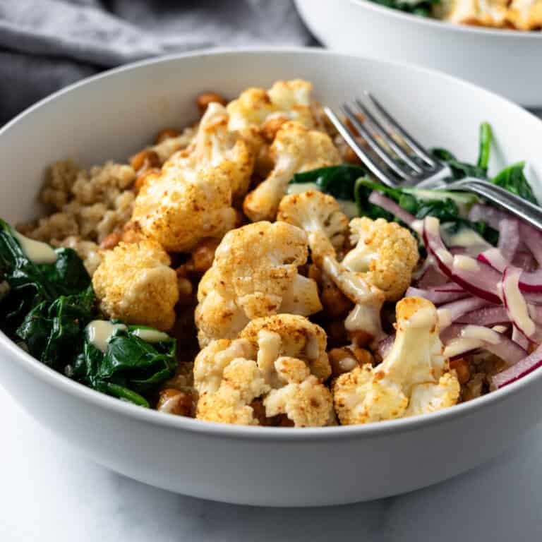 Roasted Cauliflower Bowls on a marble countertop.