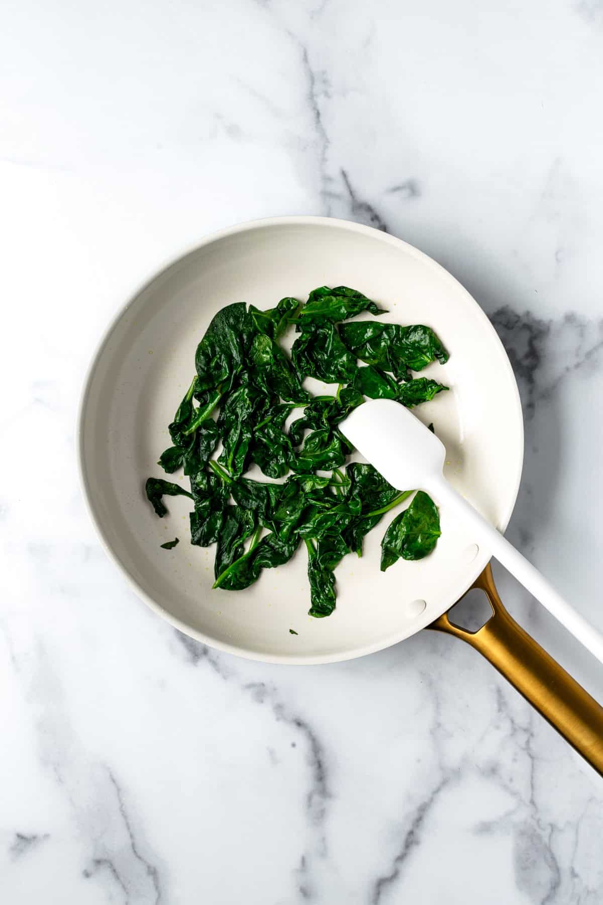 Sautéed Spinach in a White Skillet.