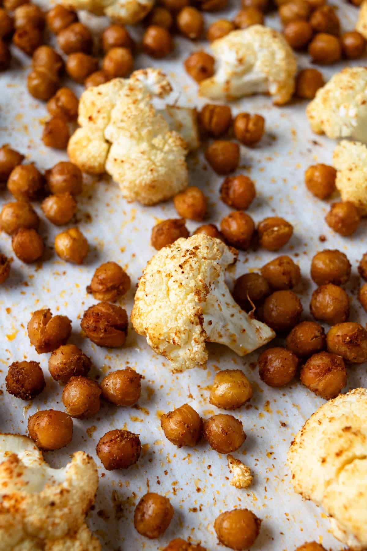 Roasted Cauliflower and Chickpeas on a parchment lined baking sheet.