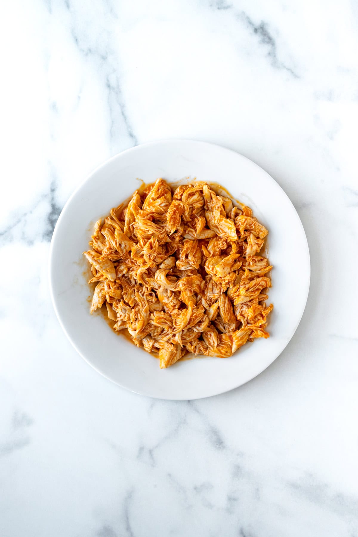 Shredded Buffalo Chicken on a white plate.