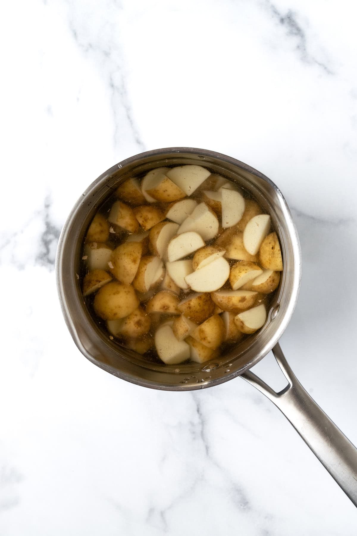 Chopped Baby Potatoes in a Pot of Water.