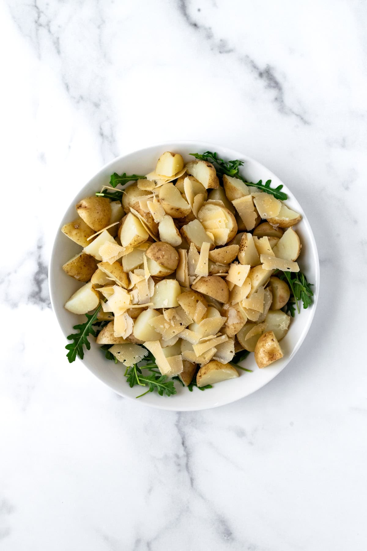 Arugula Potato Salad Ingredients in a large bowl.