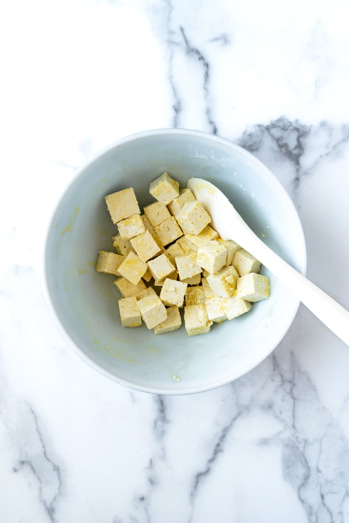Cubed Tofu with Olive Oil and Cornstarch in a Bowl.
