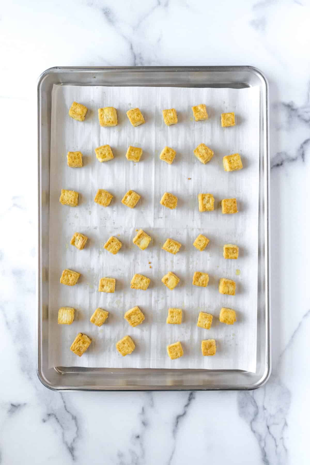 Crispy Baked Tofu Cubes on a Baking Sheet.