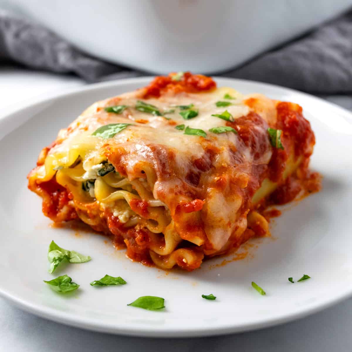 Spinach Lasagna Roll on a white plate.