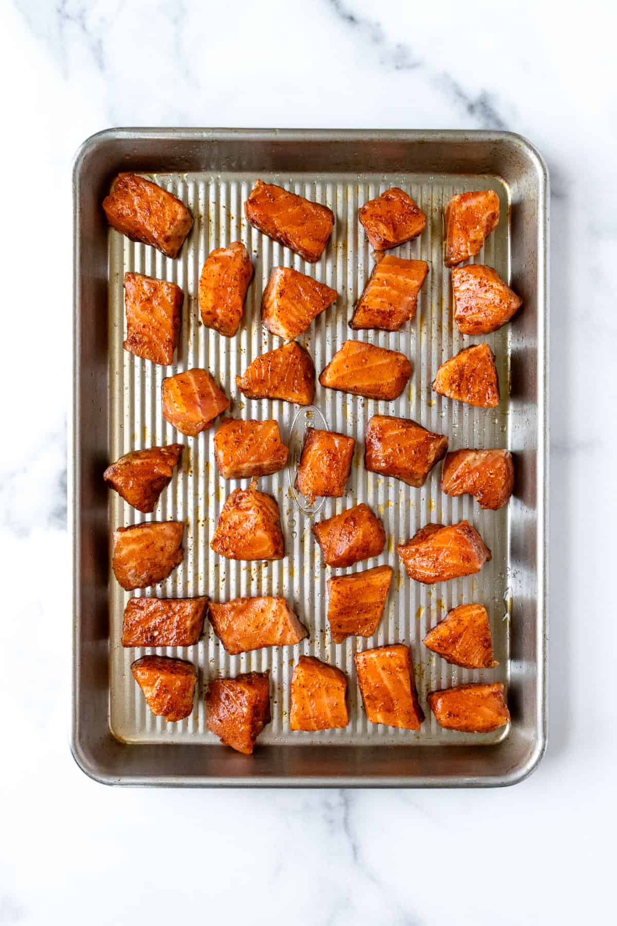 Taco Seasoned Salmon Chunks on a Baking Sheet Ready to Bake.