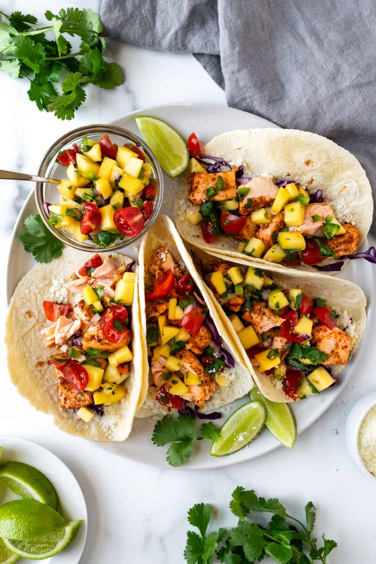 Salmon Tacos with Mango Salsa on a plate.