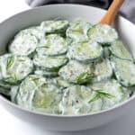Greek Yogurt Cucumber Salad in a white serving bowl.