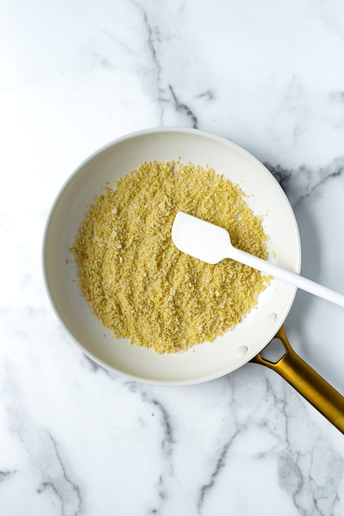 Toasted Garlic Breadcrumbs in a white skillet.