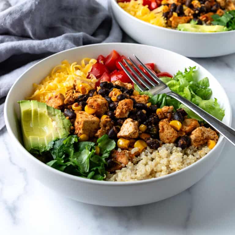 Tofu Burrito Bowls in a white bowl with a fork.