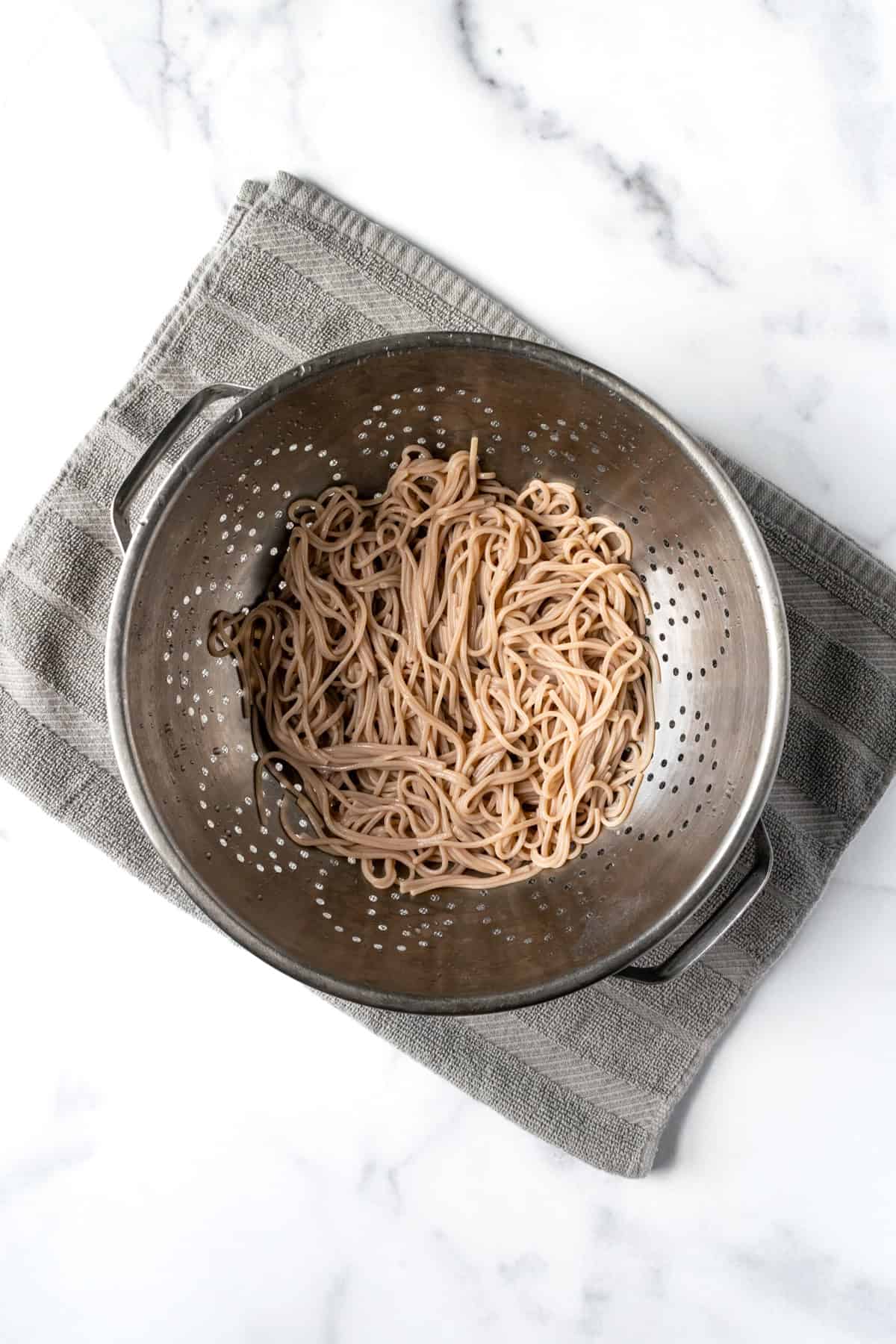 Cooked Soba Noodles in a Metal Colander.