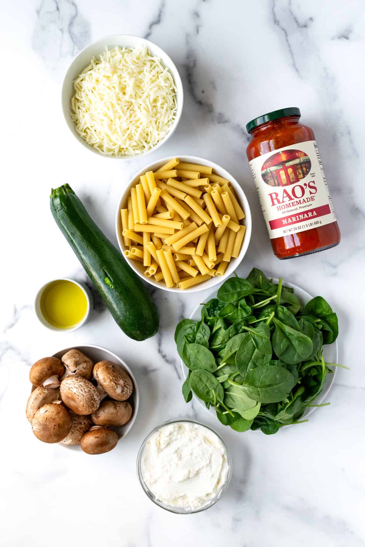 Vegetable Baked Ziti Ingredients on a marble countertop.