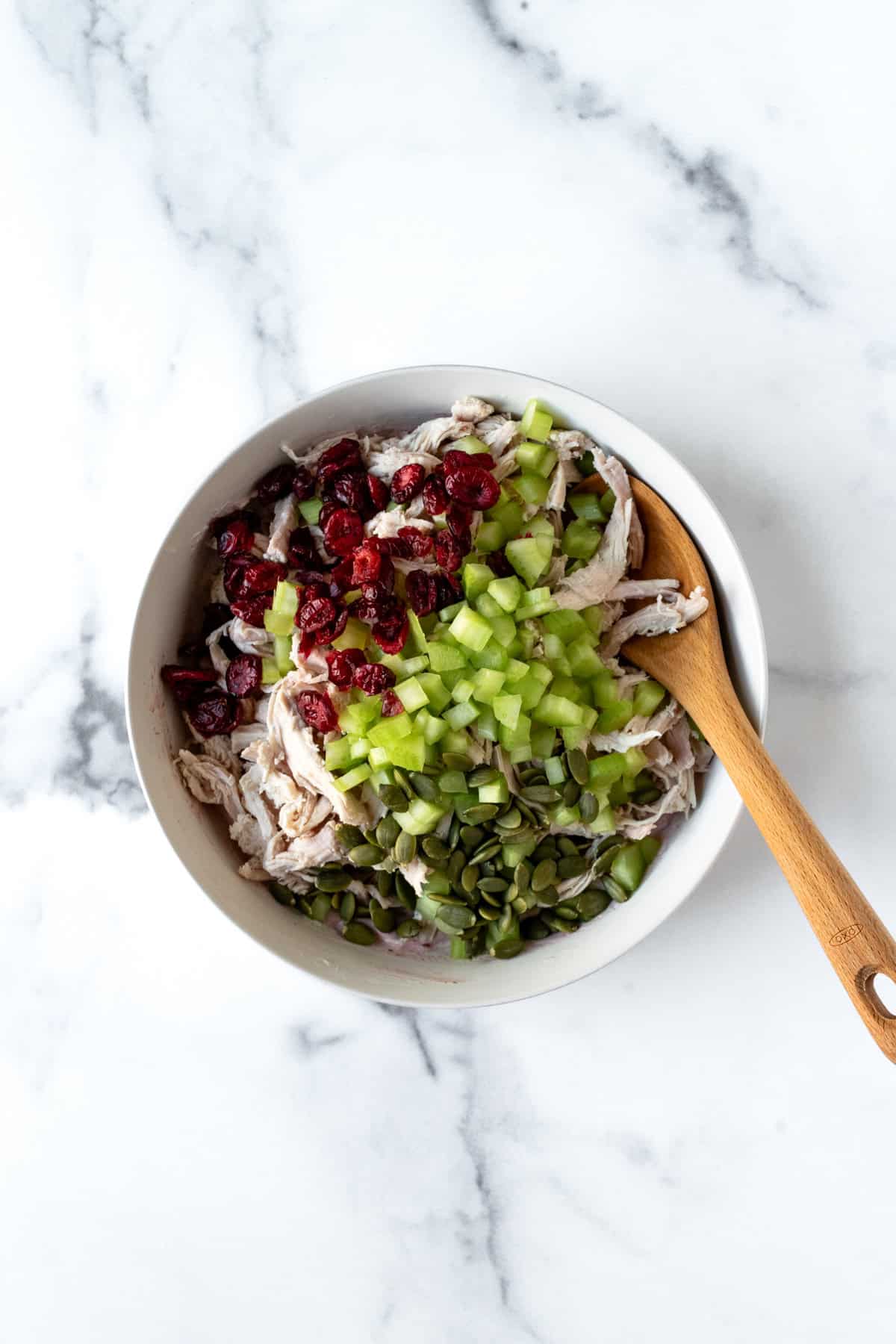 Cranberry Turkey Salad Ingredients in a white bowl.